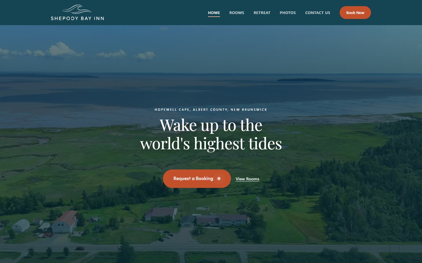 The new Shepody Bay Inn homepage on a desktop screen: a full-width video of the bay behind a single headline and one booking button.